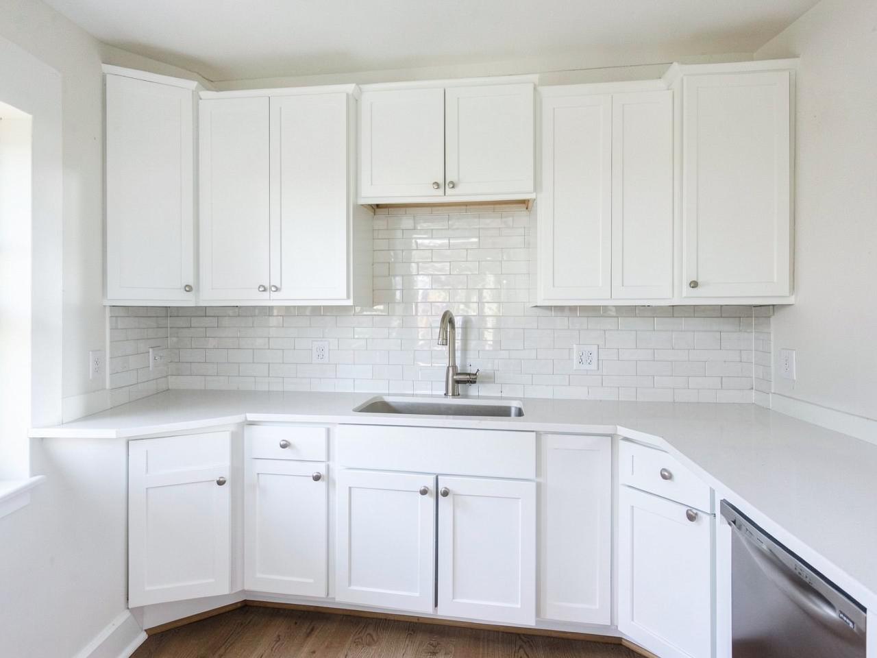 Kitchen update with white shaker cabinets, quartz counters and subway tile backsplash